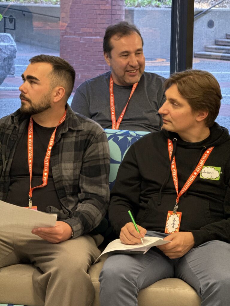 A small group speaking together during a hackathon panel.